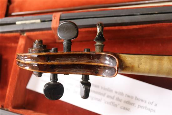 A silver mounted violin bow, an ivory mounted violin bow and a late 19th century German violin, cased